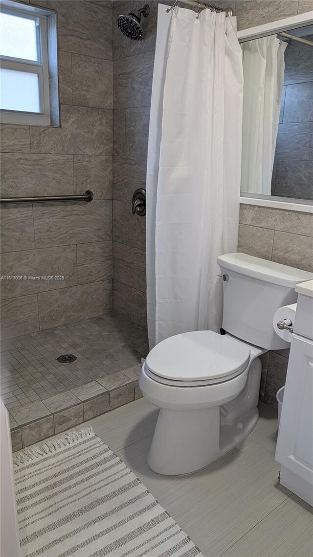 400 Golden Isles Dr Unit 10, Hallandale Beach, FL 33009 - full bath with toilet, a shower stall, vanity, and tile patterned flooring