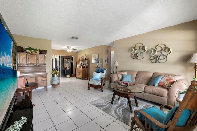 5714 NW 66th Ter, Tamarac, FL 33321 - living room featuring light tile patterned floors, a textured ceiling, and baseboards