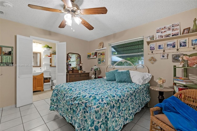 5714 NW 66th Ter, Tamarac, FL 33321 - bedroom featuring light tile patterned flooring, a textured ceiling, ensuite bath, and a ceiling fan