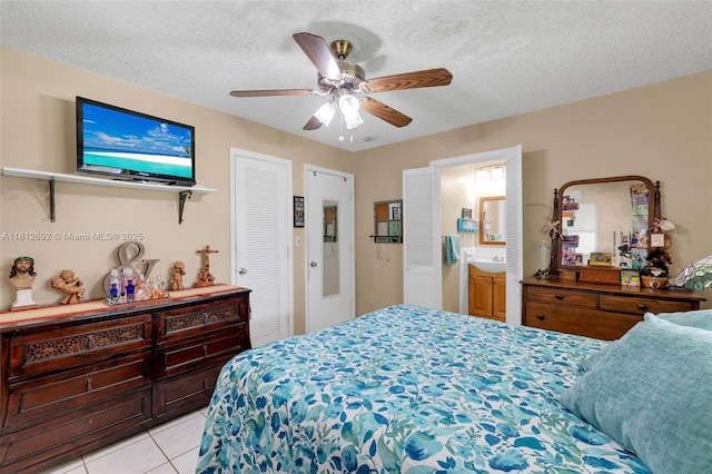 5714 NW 66th Ter, Tamarac, FL 33321 - bedroom featuring light tile patterned floors, a textured ceiling, ceiling fan, and ensuite bathroom