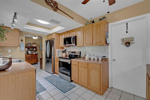 5714 NW 66th Ter, Tamarac, FL 33321 - kitchen with stainless steel appliances, a ceiling fan, a sink, and light brown cabinetry
