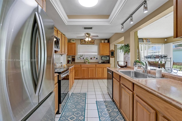 5714 NW 66th Ter, Tamarac, FL 33321 - kitchen with appliances with stainless steel finishes, a sink, a raised ceiling, light countertops, and a ceiling fan