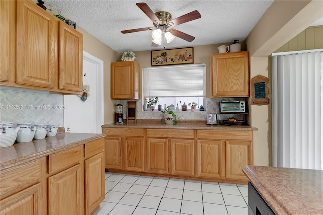 5714 NW 66th Ter, Tamarac, FL 33321 - kitchen featuring ceiling fan, backsplash, a textured ceiling, light countertops, and light tile patterned floors