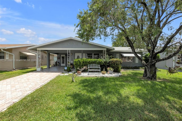 5714 NW 66th Ter, Tamarac, FL 33321 - rear view of property featuring driveway, a carport, a yard, and stucco siding