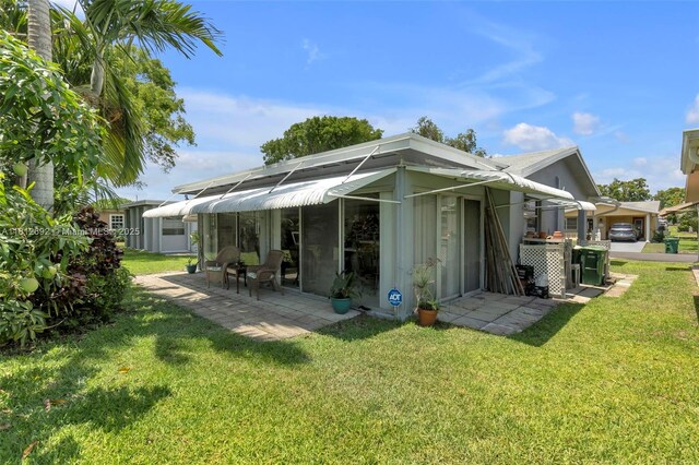 5714 NW 66th Ter, Tamarac, FL 33321 - back of house with a lawn and a patio area