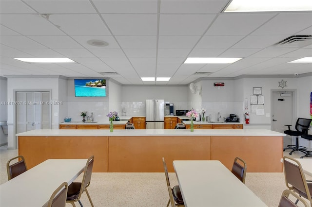 5714 NW 66th Ter, Tamarac, FL 33321 - kitchen with freestanding refrigerator, light countertops, and a sink
