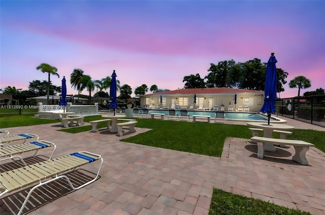 5714 NW 66th Ter, Tamarac, FL 33321 - pool at dusk featuring a patio area and a community pool