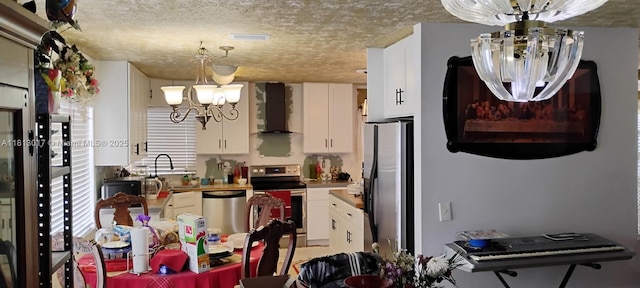 110 E Riverbend Dr, Sunrise, FL 33326 - kitchen featuring stainless steel appliances, wall chimney range hood, a chandelier, white cabinets, and a sink