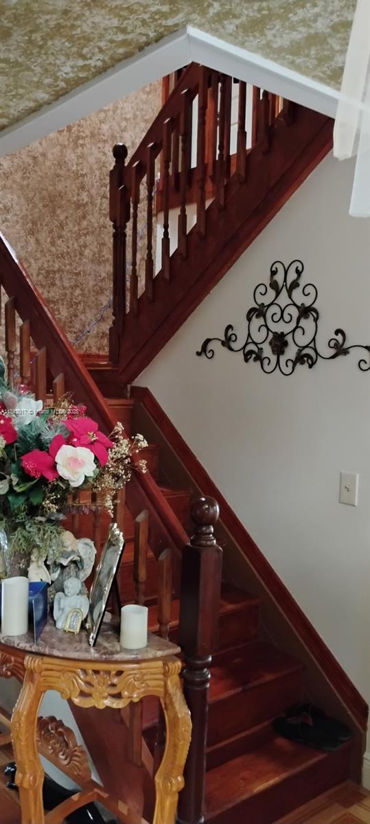 110 E Riverbend Dr, Sunrise, FL 33326 - staircase with baseboards