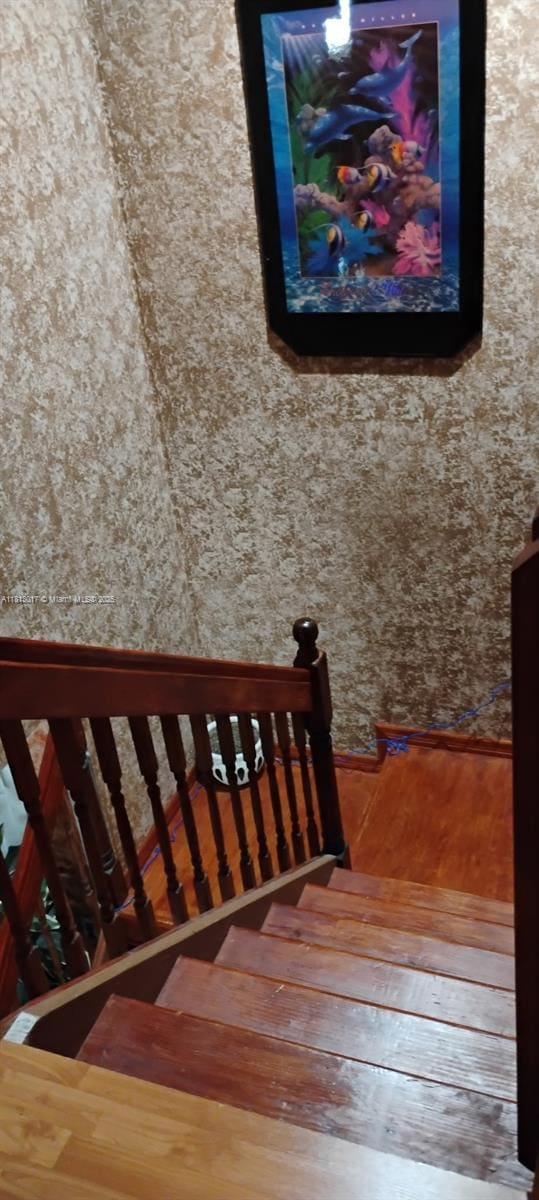 110 E Riverbend Dr, Sunrise, FL 33326 - stairway with wood-type flooring