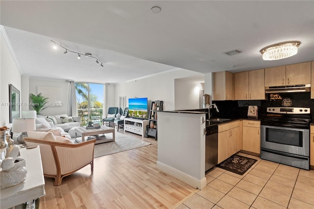 3000 Coral Way Unit 510, Miami, FL 33145 - kitchen with appliances with stainless steel finishes, light brown cabinetry, under cabinet range hood, open floor plan, and crown molding
