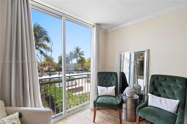 3000 Coral Way Unit 510, Miami, FL 33145 - sitting room featuring a textured ceiling, ornamental molding, wood finished floors, and healthy amount of natural light