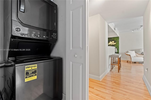3000 Coral Way Unit 510, Miami, FL 33145 - laundry area with stacked washer / drying machine, wood finished floors, and baseboards