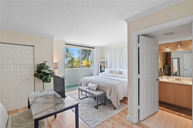 3000 Coral Way Unit 510, Miami, FL 33145 - bedroom with access to exterior, a sink, crown molding, a textured ceiling, and light wood-style floors