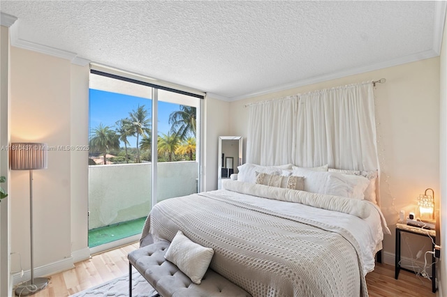 3000 Coral Way Unit 510, Miami, FL 33145 - bedroom featuring access to outside, wood finished floors, a textured ceiling, baseboards, and ornamental molding