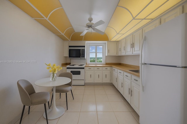 800 Parkview Dr Unit 729, Hallandale Beach, FL 33009 - kitchen featuring white appliances, ceiling fan, light tile patterned flooring, light countertops, and white cabinetry