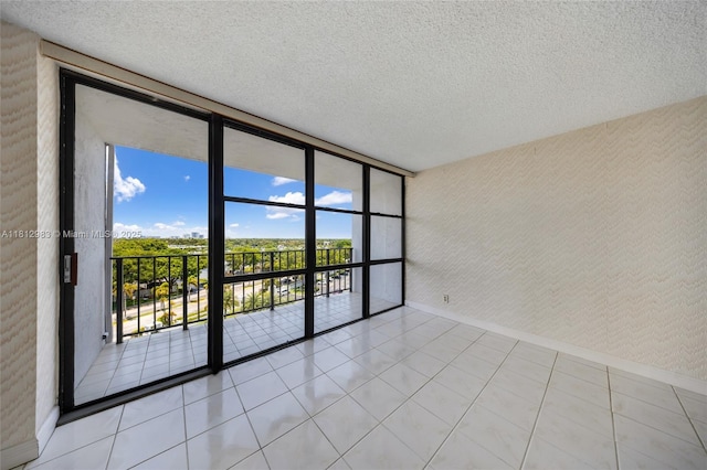 800 Parkview Dr Unit 729, Hallandale Beach, FL 33009 - unfurnished room featuring floor to ceiling windows, baseboards, a textured ceiling, and tile patterned floors