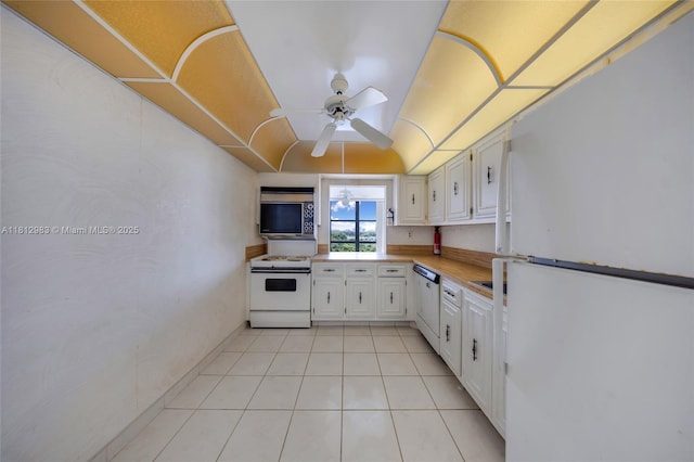 800 Parkview Dr Unit 729, Hallandale Beach, FL 33009 - kitchen with white appliances, light countertops, a ceiling fan, light tile patterned flooring, and white cabinetry