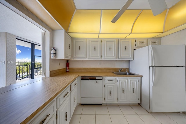 800 Parkview Dr Unit 729, Hallandale Beach, FL 33009 - kitchen featuring white appliances, a sink, light countertops, light tile patterned flooring, and white cabinetry