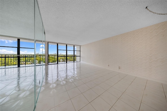 800 Parkview Dr Unit 729, Hallandale Beach, FL 33009 - spare room with floor to ceiling windows, plenty of natural light, a textured ceiling, and tile patterned flooring