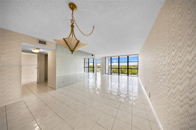 800 Parkview Dr Unit 729, Hallandale Beach, FL 33009 - tiled spare room with wallpapered walls, expansive windows, baseboards, and a textured ceiling