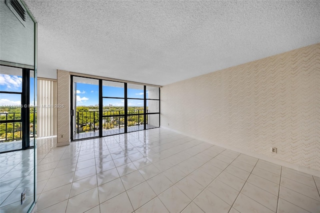 800 Parkview Dr Unit 729, Hallandale Beach, FL 33009 - spare room with floor to ceiling windows, a textured ceiling, and baseboards