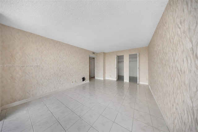 800 Parkview Dr Unit 729, Hallandale Beach, FL 33009 - empty room featuring a textured ceiling, baseboards, and light tile patterned floors