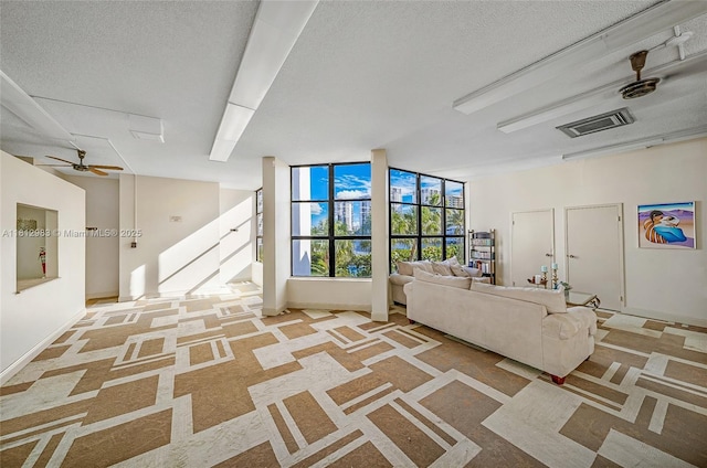 800 Parkview Dr Unit 729, Hallandale Beach, FL 33009 - living room featuring light colored carpet, a textured ceiling, stairs, baseboards, and ceiling fan