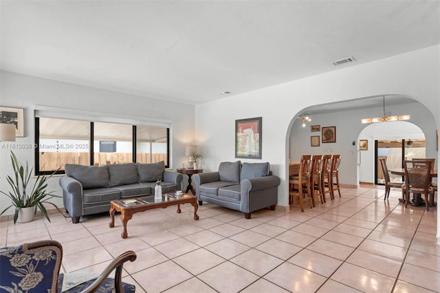 525 NW 32nd Ave, Miami, FL 33125 - living area featuring arched walkways and light tile patterned floors