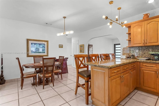 525 NW 32nd Ave, Miami, FL 33125 - kitchen with arched walkways, tasteful backsplash, a peninsula, open shelves, and hanging light fixtures