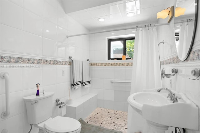 525 NW 32nd Ave, Miami, FL 33125 - full bath featuring tile walls, tiled shower, toilet, tile patterned floors, and wainscoting