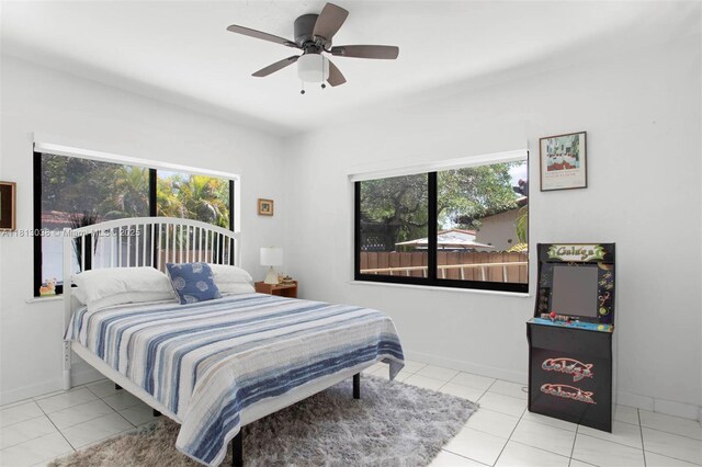 525 NW 32nd Ave, Miami, FL 33125 - bedroom with multiple windows, tile patterned floors, a ceiling fan, and baseboards