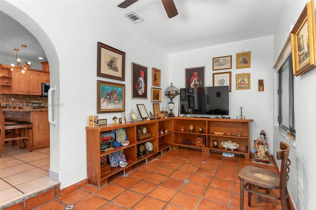 525 NW 32nd Ave, Miami, FL 33125 - living area featuring arched walkways, ceiling fan, and tile patterned floors
