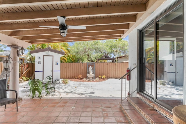 525 NW 32nd Ave, Miami, FL 33125 - fenced backyard with a patio and ceiling fan