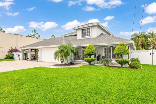 6459 Ungerer St, Jupiter, FL 33458 - view of front of property with a gate, stucco siding, a garage, roof with shingles, and concrete driveway