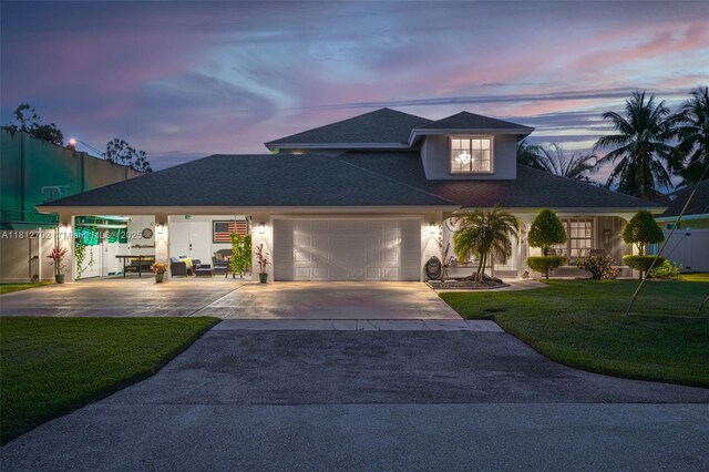 6459 Ungerer St, Jupiter, FL 33458 - view of front facade with concrete driveway, a garage, and roof with shingles