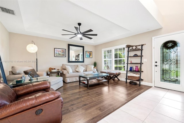 6459 Ungerer St, Jupiter, FL 33458 - tiled living room with a tray ceiling and a ceiling fan