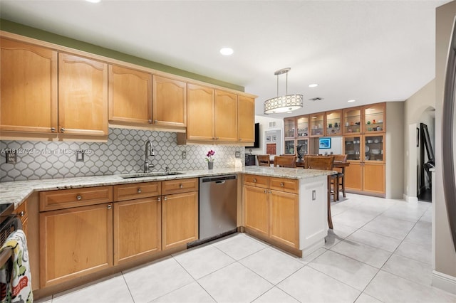 6459 Ungerer St, Jupiter, FL 33458 - kitchen with dishwasher, a sink, a peninsula, backsplash, and light stone countertops