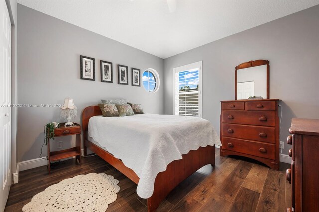 6459 Ungerer St, Jupiter, FL 33458 - bedroom featuring dark wood-type flooring and baseboards