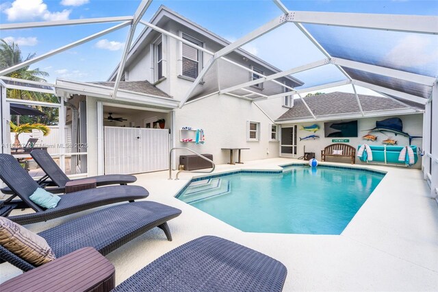 6459 Ungerer St, Jupiter, FL 33458 - outdoor pool featuring a patio area, glass enclosure, and ceiling fan