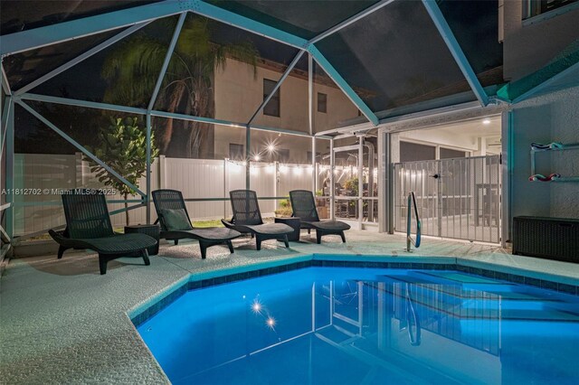 6459 Ungerer St, Jupiter, FL 33458 - pool at twilight with a patio area and a lanai