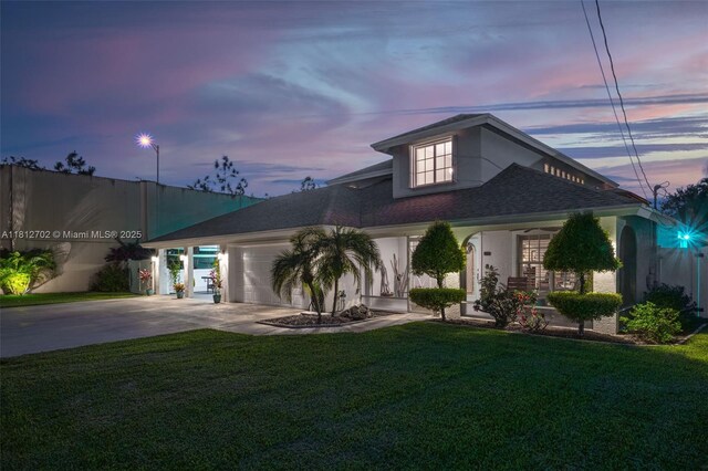 6459 Ungerer St, Jupiter, FL 33458 - view of front of house featuring concrete driveway, a garage, a yard, a shingled roof, and stucco siding
