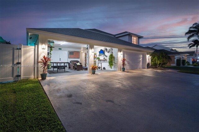 6459 Ungerer St, Jupiter, FL 33458 - view of property exterior featuring a garage and driveway