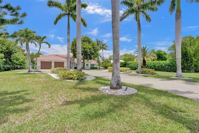 5963 NW 75th Way, Parkland, FL 33067 - view of grassy yard featuring curved driveway and an attached garage