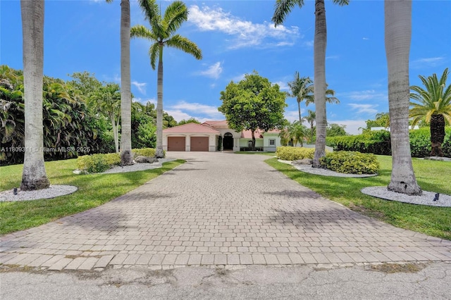5963 NW 75th Way, Parkland, FL 33067 - view of front of home with an attached garage, decorative driveway, and a front yard