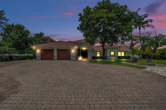 5963 NW 75th Way, Parkland, FL 33067 - mediterranean / spanish-style home featuring decorative driveway, a garage, stucco siding, and a tiled roof