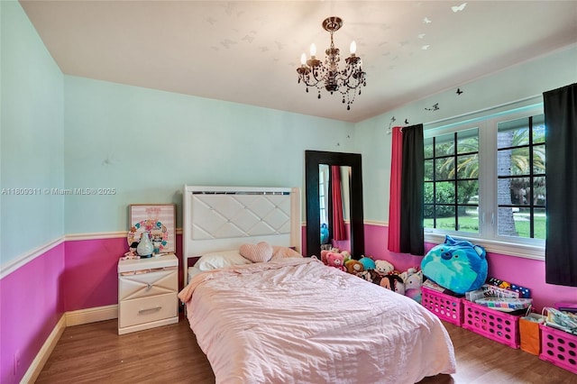 5963 NW 75th Way, Parkland, FL 33067 - bedroom with wood finished floors, a chandelier, and baseboards