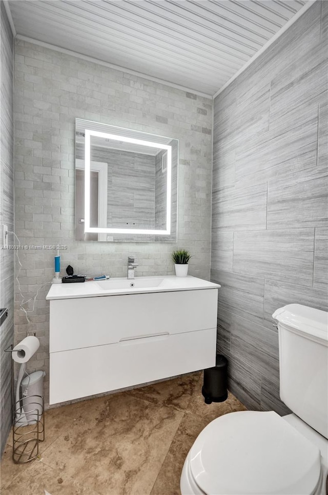 5963 NW 75th Way, Parkland, FL 33067 - bathroom featuring tile walls, vanity, and toilet