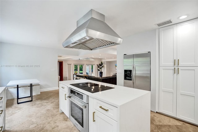 5963 NW 75th Way, Parkland, FL 33067 - kitchen with island exhaust hood, appliances with stainless steel finishes, and white cabinets