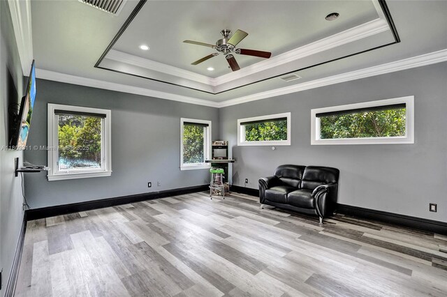 5963 NW 75th Way, Parkland, FL 33067 - sitting room featuring a tray ceiling, wood finished floors, a ceiling fan, crown molding, and baseboards
